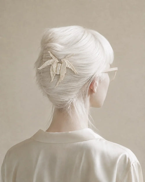 Halo Pearl wing claw clip worn in a French twist, seen from behind